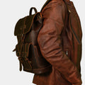 Side pose with model hanging Premium Brown Leather Backpack for Travel, Work and Everyday Use