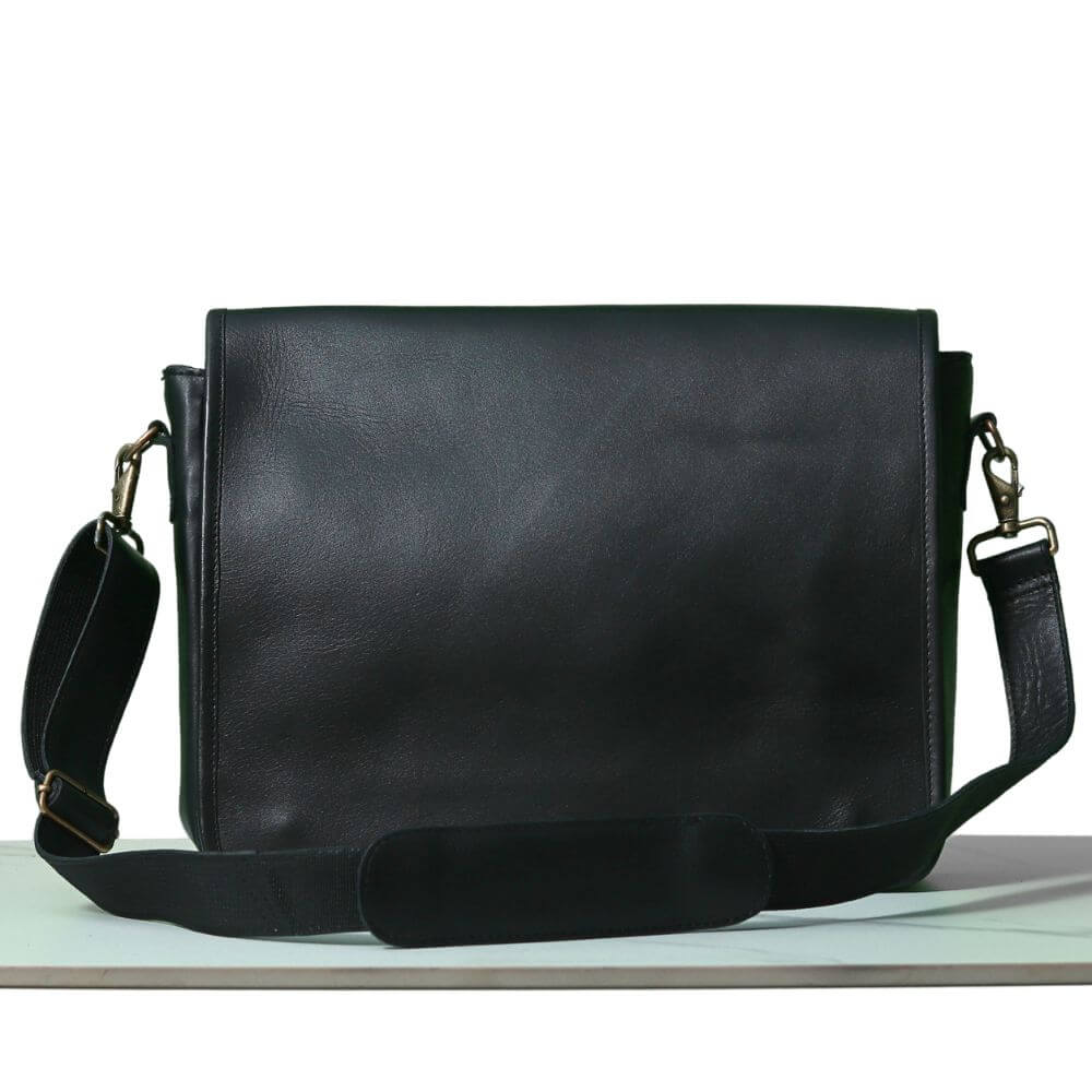 Full-grain The Black Executive leather messenger bag with a slim, structured design, featuring a secure flap closure and adjustable shoulder strap for comfortable carrying.