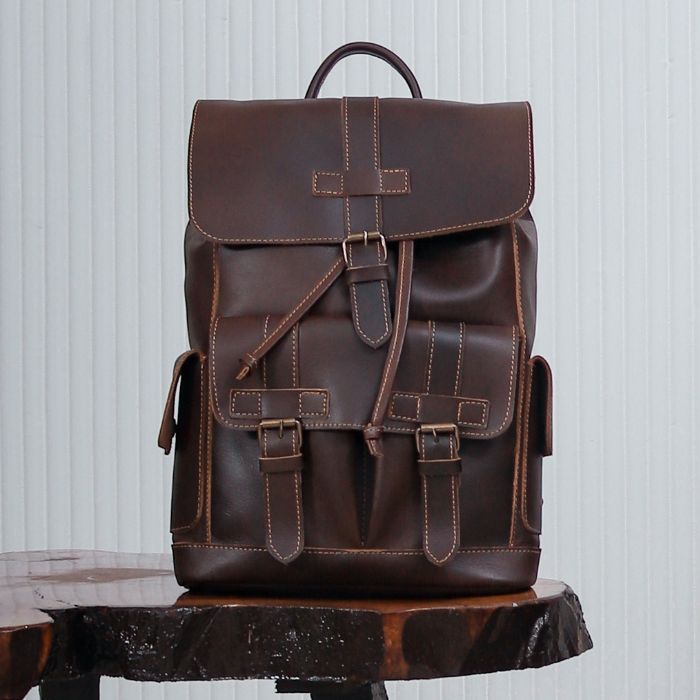 Minimalist  Brown leather backpack with adjustable straps, perfect for city commuting