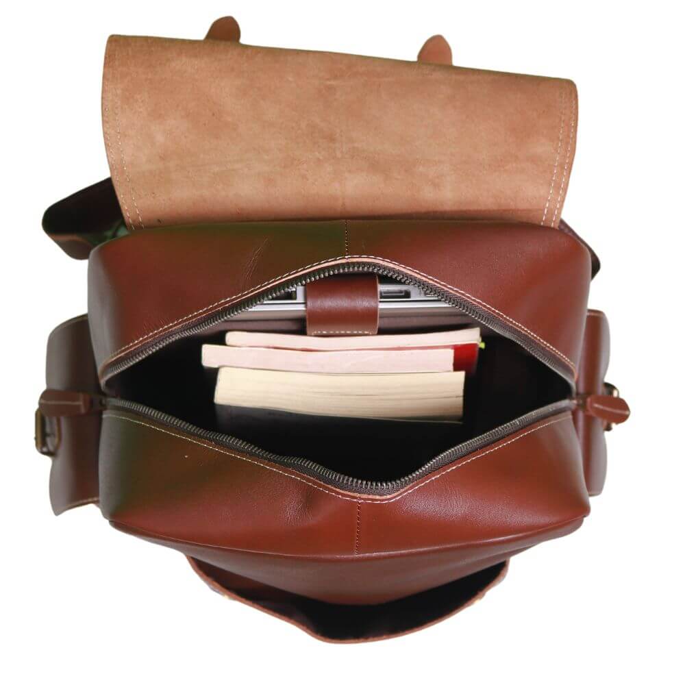 Inside view Urban Nomad Leather Backpack showing books while laptop placed in padded laptop compartment