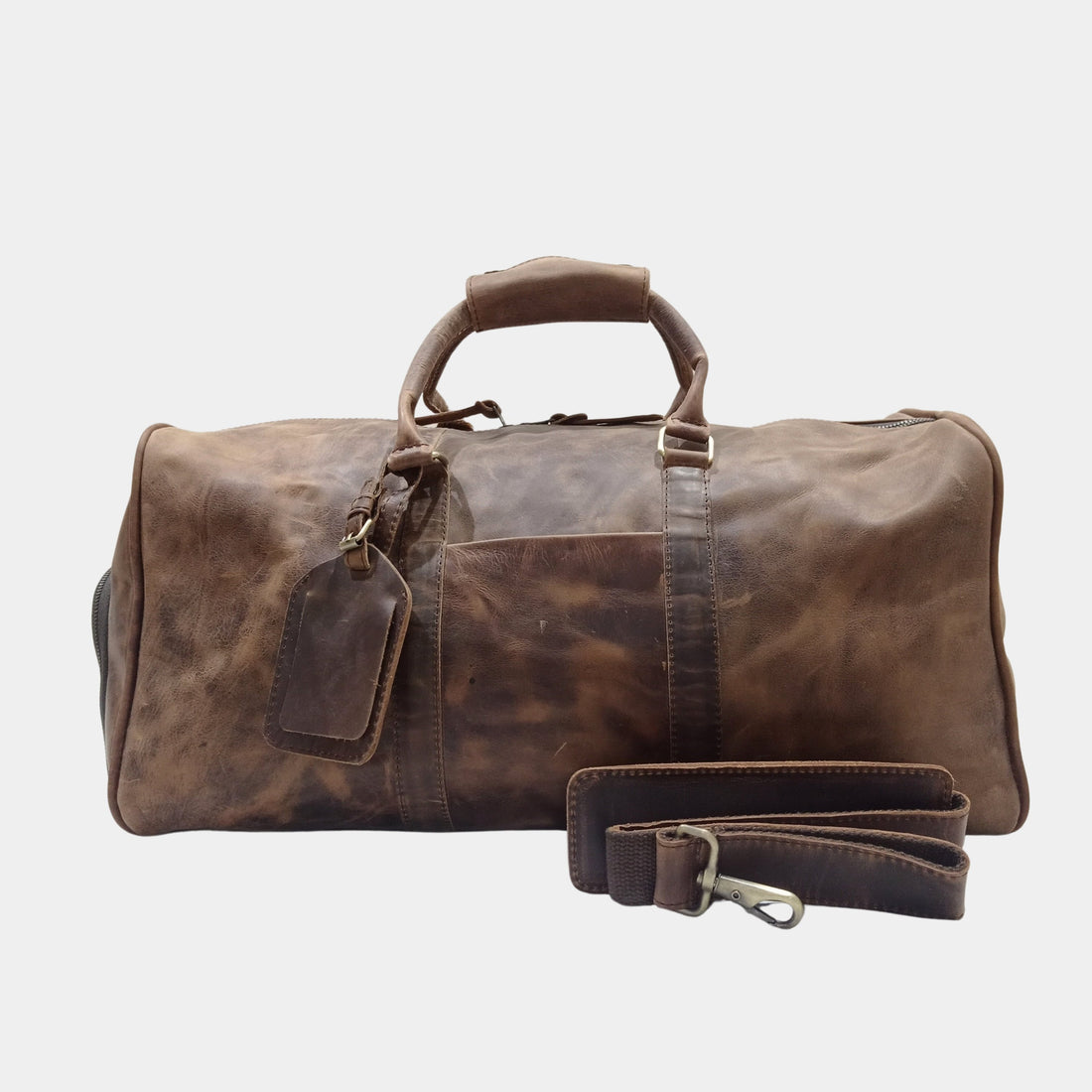 Handmade leather duffle bag with full-grain leather, showcasing durable stitching and a spacious interior for travel or gym use.