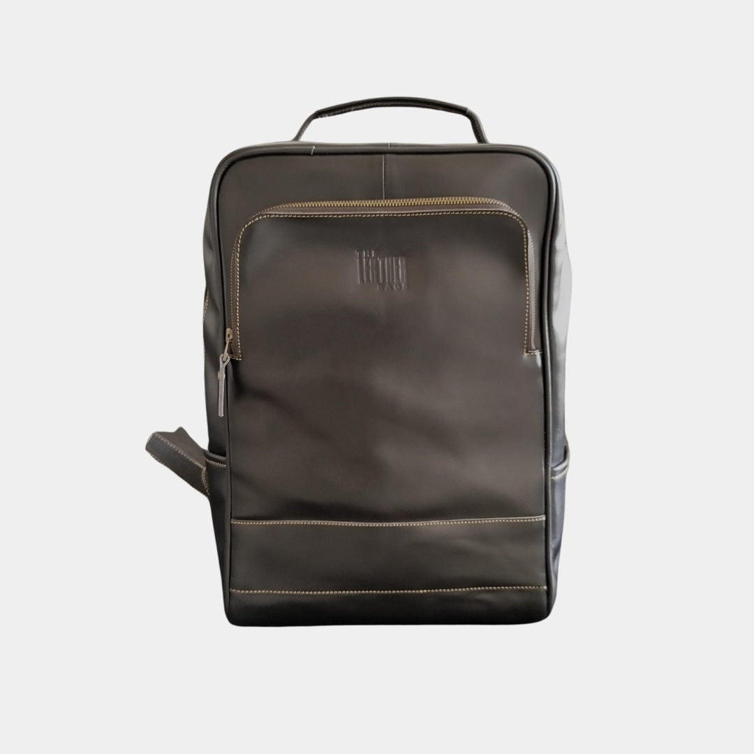 Front view of black Grampian leather backpack showing front zipper pocket having a padded laptop compartment inside