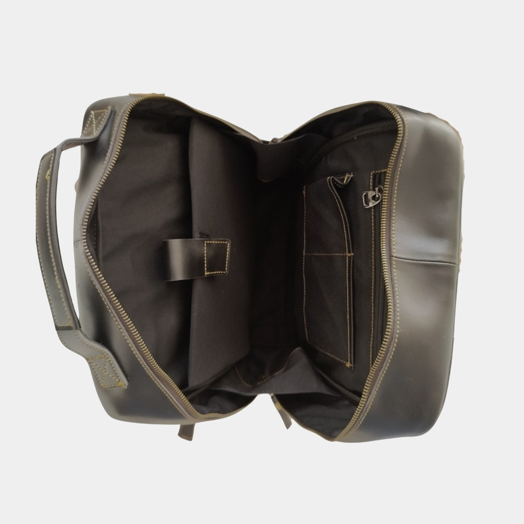 Inside view of Black Leather Backpack showing padded laptop compartment two slip slot and inner zipper organization pocket with soft cotton lining