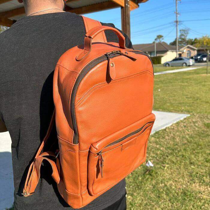 Model in black shirt posing Laptop Explorer Leather Backpack in outdoor Australian Setting