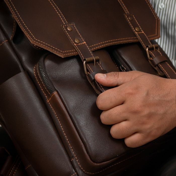 Model showcasing Travel friendly leather backpack with easy access pockets and secure magnetic closures