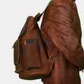 model in brown jacket posing Side view of premium leather backpack by TLB Australia