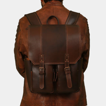  Model in brown jacket posing Australian made Voyager Classic leather backpack, crafted for durability and style