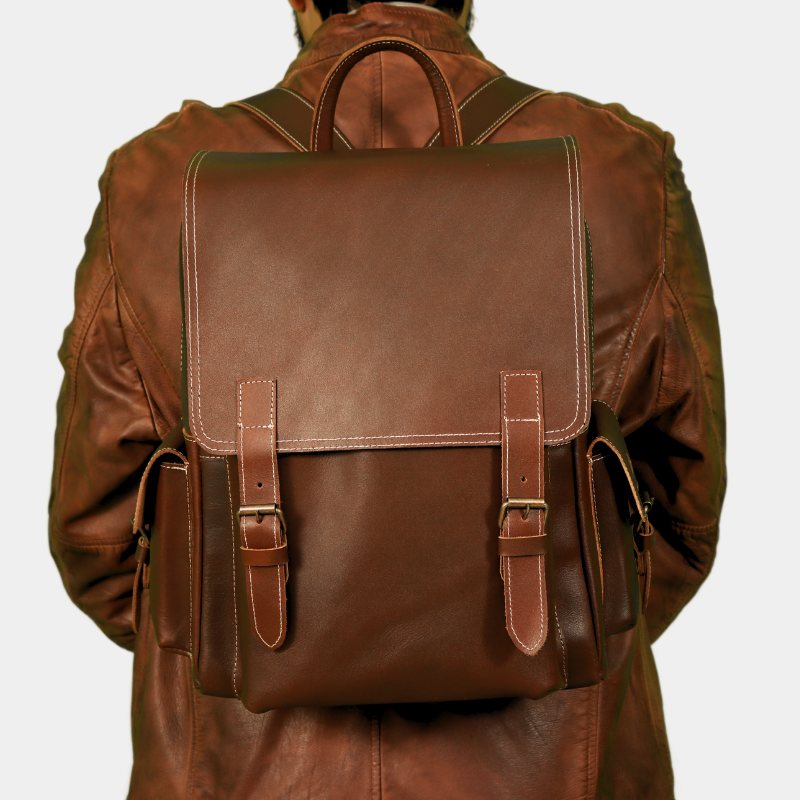 Model posing with Premium Urban Nomad leather backpack for men and women, perfect for travel in Australia