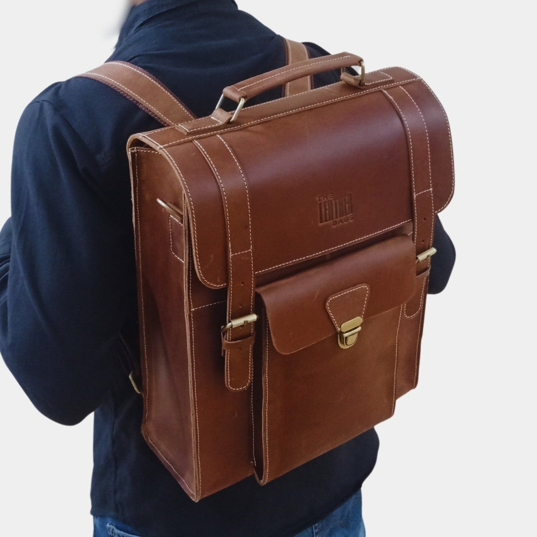 A model posing with Vintage Brown Tassie Leather Briefcase Backpack at his back