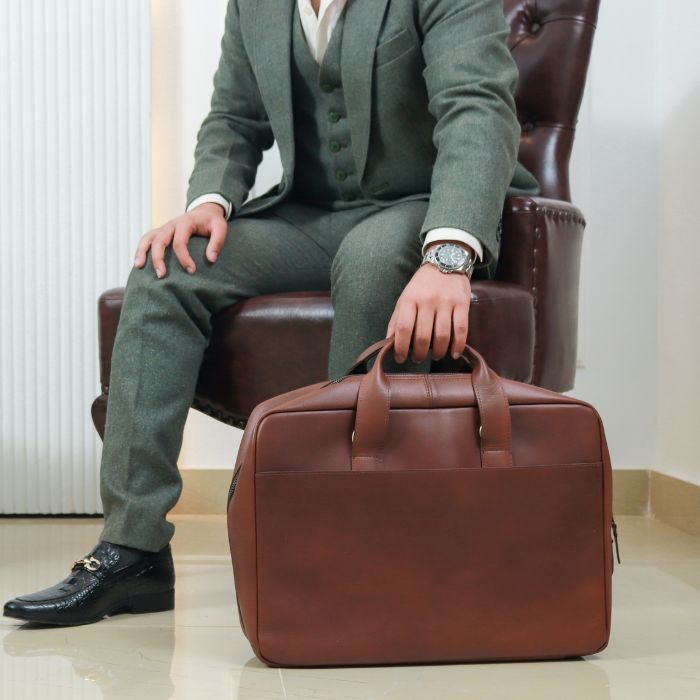 Model Posing while holding Melbourne Metro Leather Messenger  Bag placed on floor