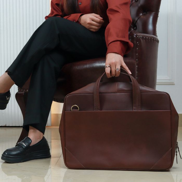 Model holding Nomad Essential Laptop Messenger bag in her hands 