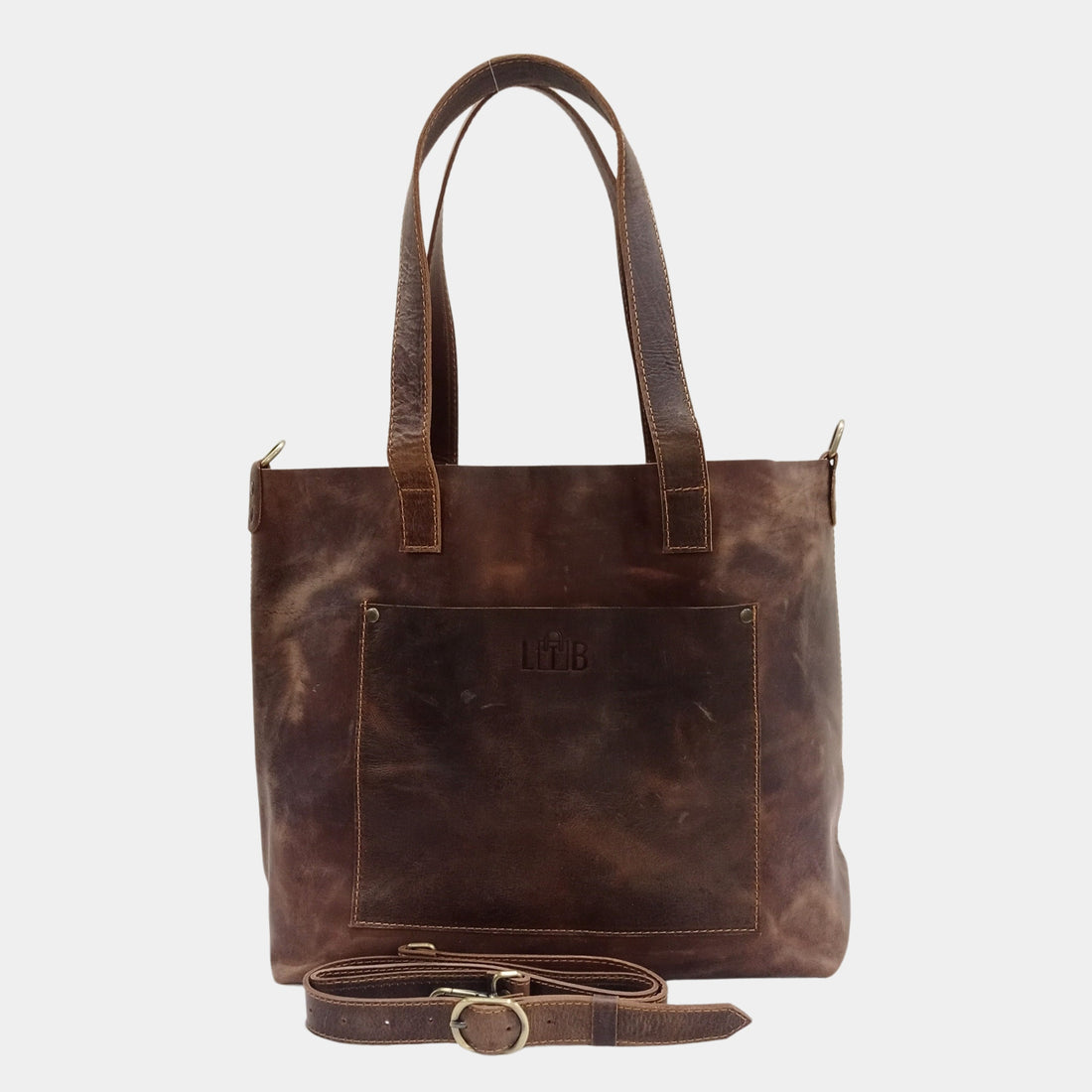 Teenage girl in white shirt elegantly carrying large brown work tote with durable removable straps 