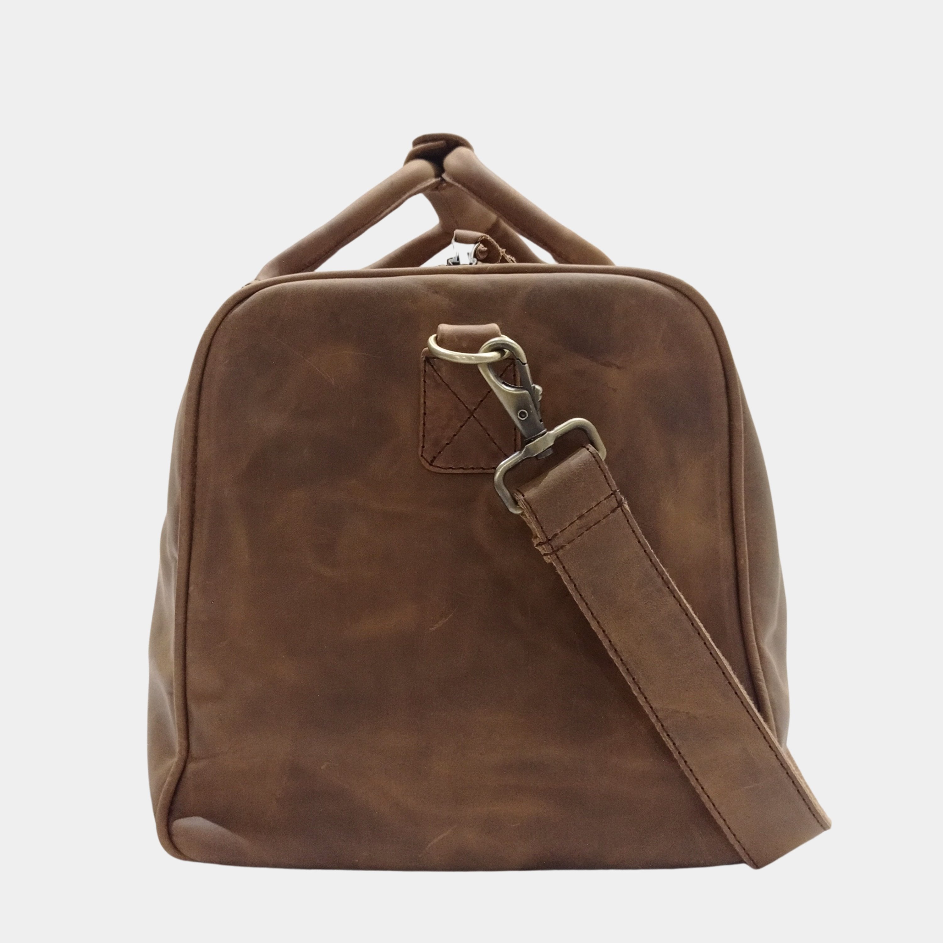 Side view of Eyre Brown Leather Duffle showing elegant brass hardware