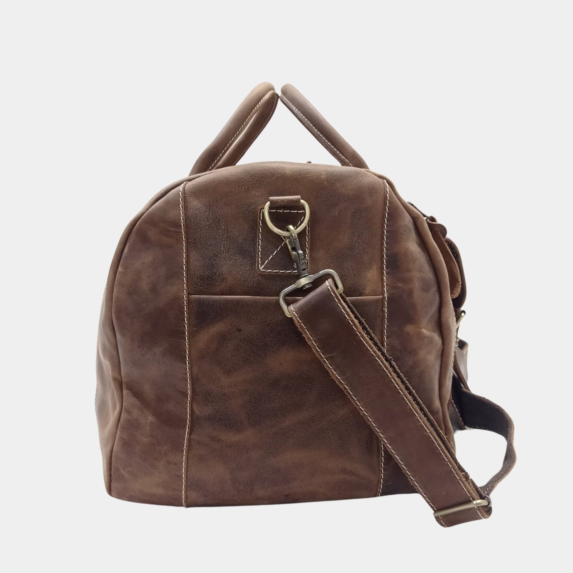 Left side View of Roma Leather Duffle Bag showing slip pocket and brass hooks of shoulder strap 