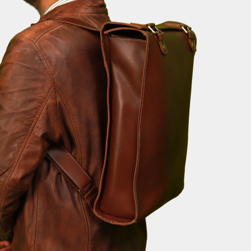 Model Posing Stylish Brown Executive Edge leather backpack while wearing using adjustable straps 
