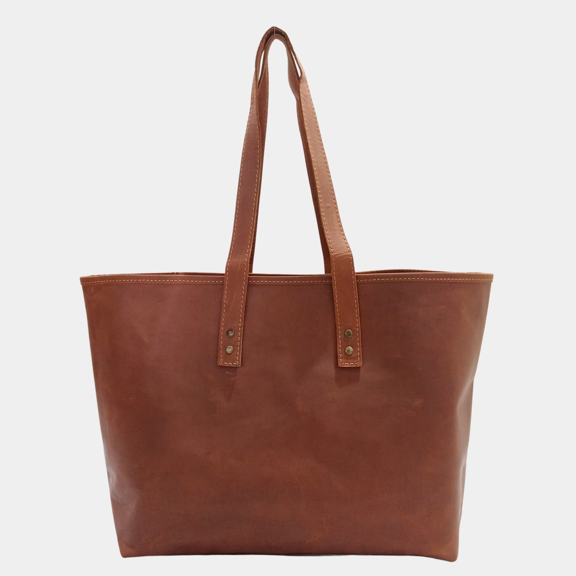 Brown leather tote bag on a white background