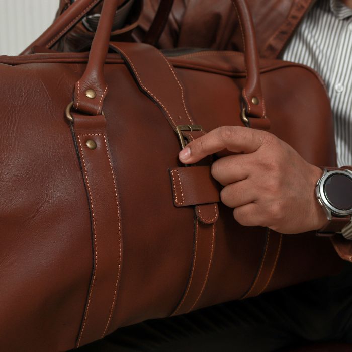 Model showcasing elegant brass Buckle of Aussie Leather Duffle Bag