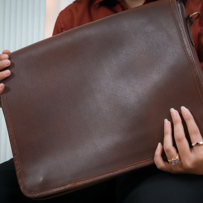 Model Holding Brown Crossbody 
 Leather Messenger in her Hands