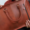  A model Holding Metro Messenger Maven bags showcasing its fine stitching