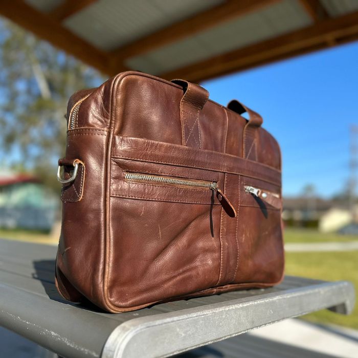 The Tech Savvy Brown Leather Messenger Bag showing two front zipper pockets