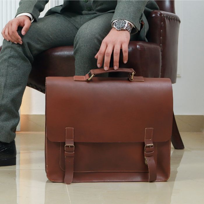 Model posing with Business Navigator Messenger By TLB Australia while sitting on sofa