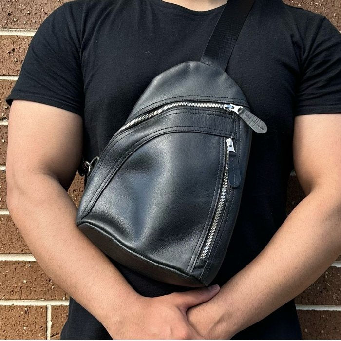 A man wear leather sling bag