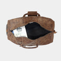 Packed Eyre Leather Duffle Bag with clothes and a book placed on top of clothes