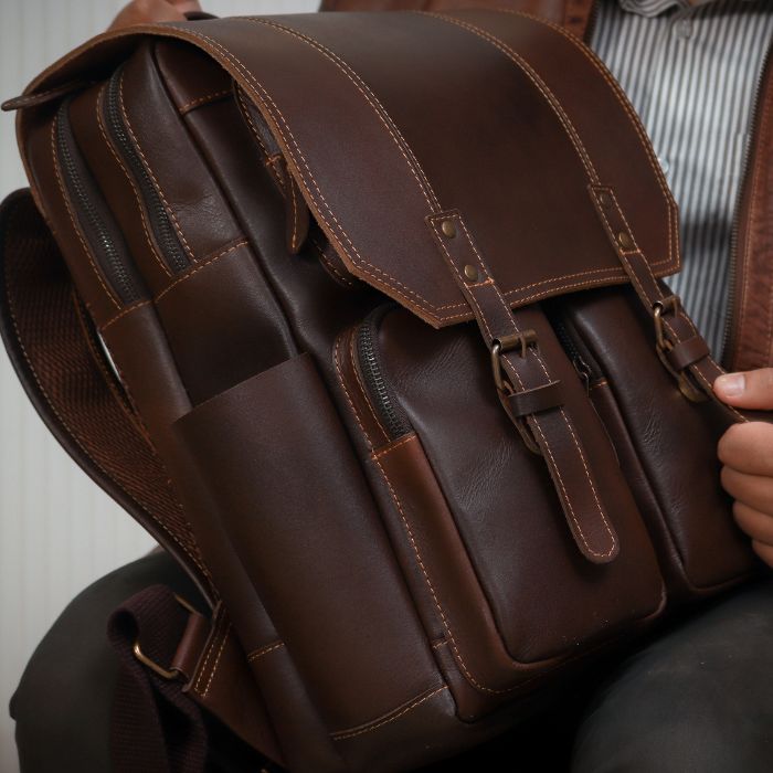  Model in brown jacket posing Australian made Voyager Classic leather backpack, crafted for durability and style